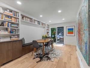 Dining room with built in shelving and long banquet
