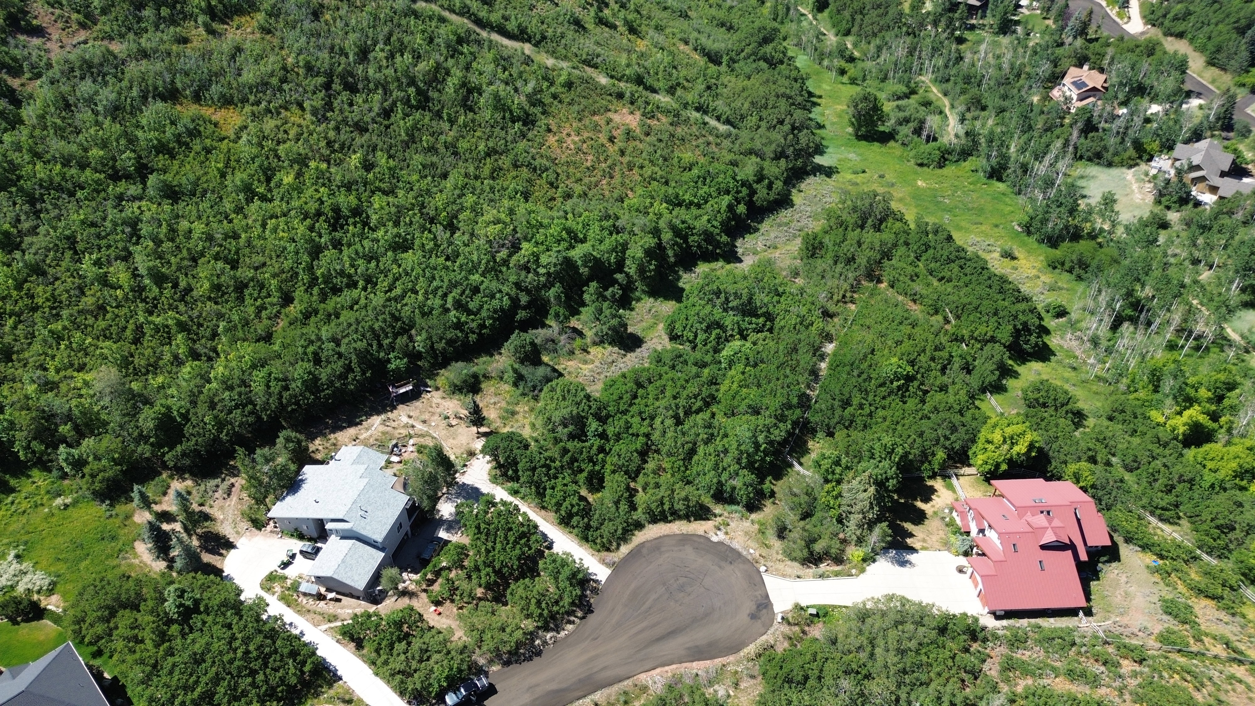 View of property location featuring a forest