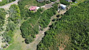 Aerial overview of property's location featuring a heavily wooded area