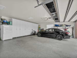 Garage featuring freestanding refrigerator
