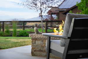 View of patio / terrace featuring a mountain view, an outdoor fire pit, and grilling area