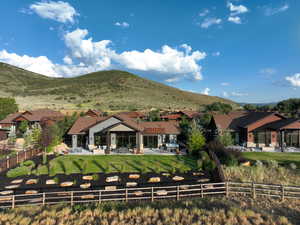 Rear view of house featuring a patio, a fenced backyard, and a mountain view