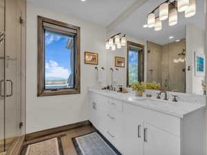 Full bath featuring double vanity, a shower stall, and recessed lighting