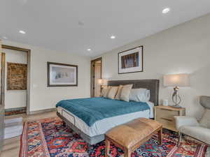 Bedroom with light wood finished floors and recessed lighting