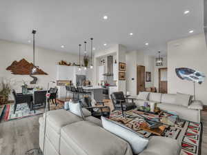 Living room featuring light wood finished floors, recessed lighting, and a chandelier