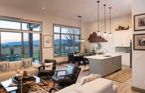 Living room featuring light wood-style flooring, recessed lighting, and a mountain view