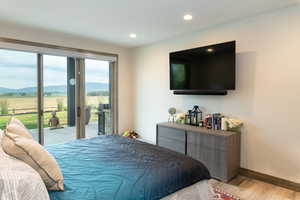 Bedroom featuring access to outside, light wood finished floors, and recessed lighting