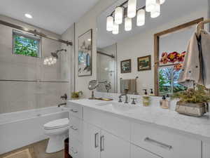 Full bath with vanity, plenty of natural light, and shower / bathtub combination