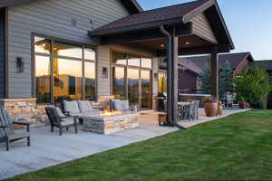 View of patio / terrace featuring area for grilling and an outdoor living space with a fire pit
