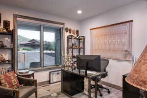 Office space with wood finished floors and recessed lighting