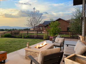 View of patio featuring an outdoor living space with a fire pit