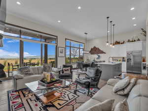 Living area featuring light wood-style floors and recessed lighting