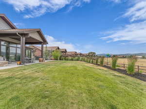 Fenced backyard featuring a patio