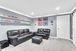 Basement Family room with a barn door, carpet flooring, and recessed lighting