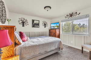 Jr Suite Bedroom #2 with carpet, a decorative wall, and a wainscoted wall, Bathroom Attached