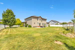 Fenced backyard featuring a patio and outdoor lounge area