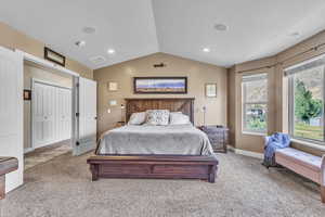 Master bedroom with vaulted ceiling, carpet, and recessed lighting