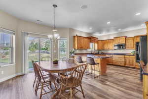 Dining space featuring recessed lighting, a chandelier, and light wood-style floors