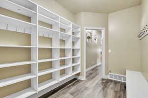 Mudroom featuring wood finished floors and baseboards