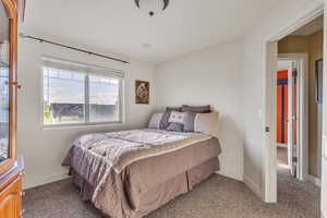 Carpeted bedroom #4  featuring baseboards