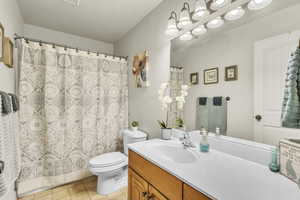 Full bath with vanity and a shower with shower curtain