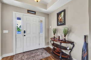 Foyer featuring baseboards and wood finished floors