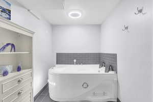 Full bathroom featuring 2 person Hot Tub and tile patterned flooring