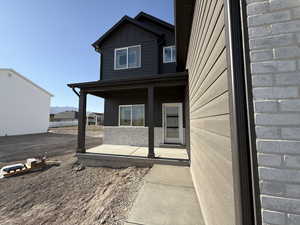 Doorway to property featuring board and batten siding