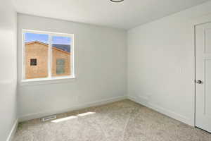 Unfurnished room with carpet and baseboards
