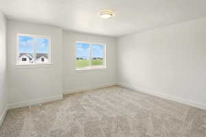 Empty room with carpet flooring and baseboards