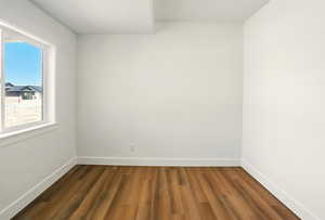 Empty room featuring dark wood-style floors