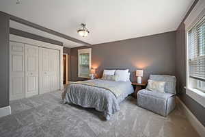 Owners bedroom featuring carpet, multiple windows, and a closet