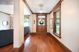 Foyer featuring a chandelier, hardwood / wood-style flooring, and ornamental molding