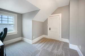 Unfurnished office with lofted ceiling and carpet