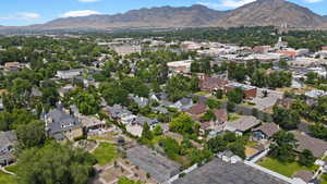 Aerial view of property's location with a mountainous background and nearby suburban area