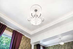 Detailed view of a chandelier and crown molding