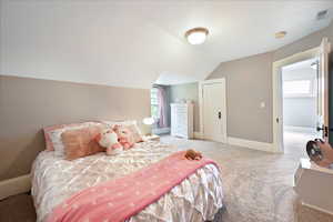 Bedroom with carpet and vaulted ceiling