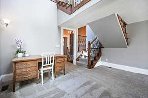 Home office featuring baseboards and carpet