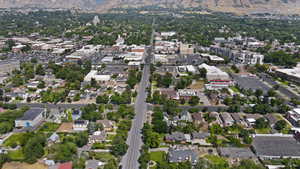 Aerial overview of property's location featuring mountains and nearby suburban area