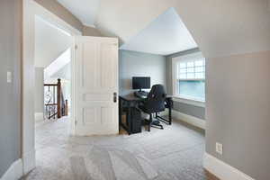 Office space with carpet and lofted ceiling