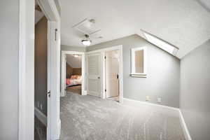 Bonus/landig area with carpet floors and lofted ceiling