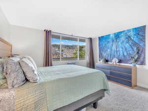 Bedroom featuring carpet flooring and baseboards