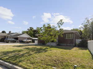 Single story home featuring a detached carport