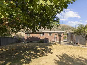 Rear view of house featuring a mountain view and brick siding