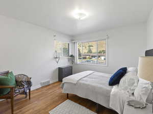 Bedroom featuring light wood finished floors and baseboards
