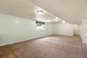 Below grade area featuring a textured ceiling and baseboards