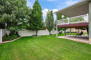 Fenced backyard with a patio and a wooden deck