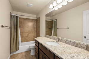 Full bathroom featuring vanity and shower / tub combo with curtain
