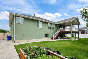 Rear view of house with a patio area, stucco siding, stairway, and a shingled roof