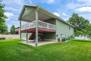 Back of house with a patio, a wooden deck, stucco siding, and stairs